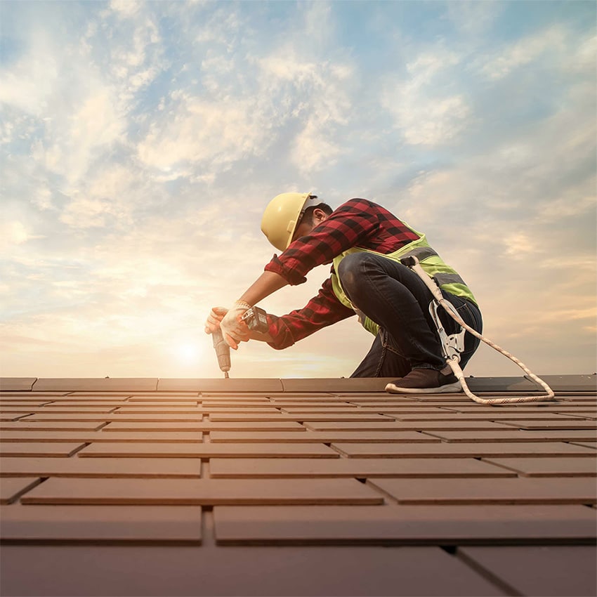 An image of a roofer actively working on a roof.